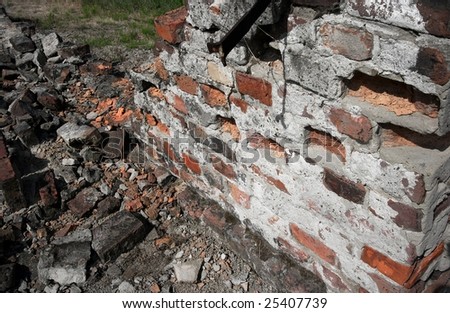 Pile of debris of ruined brick wall of a building