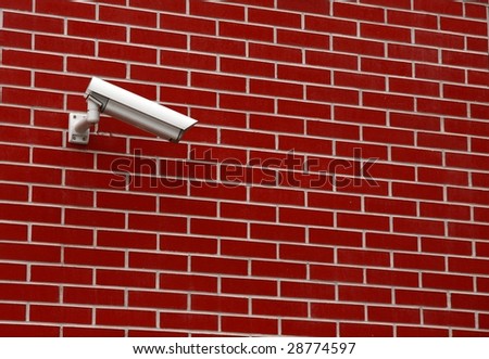 Street security camera on a brick wall