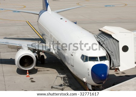Commercial airplane parked at an airport terminal