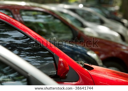 Parking cars, focus on the red one