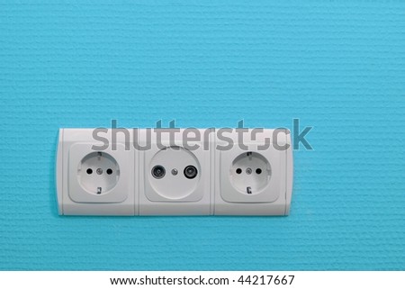 Electric sockets on blue wall