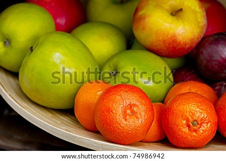 Fruits in a bowl, shallow focus in the front, smooth background