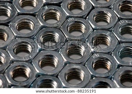 Metal nuts in an organized array pattern