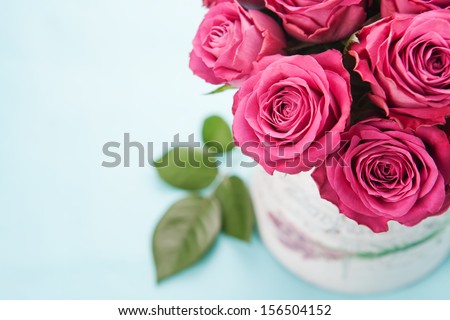 Bouquet of beautiful pink roses on light blue background