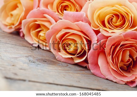 Bouquet of beautiful roses on wooden background