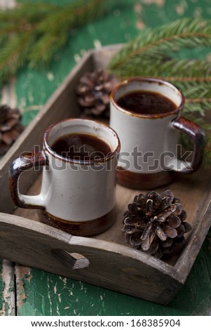 Two cups of coffee on wooden tray on old wooden table