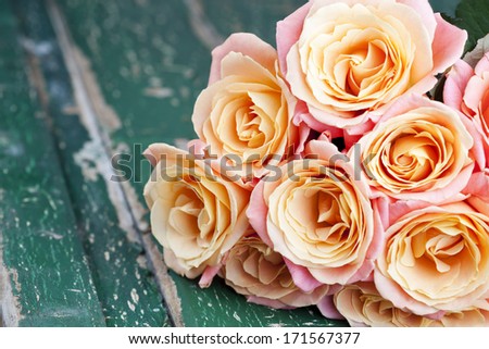 Bouquet of beautiful roses on wooden background