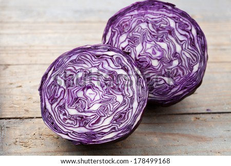 Red cabbage section on wooden background