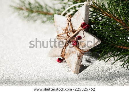 Christmas card idea with wooden star and branches of xmas tree