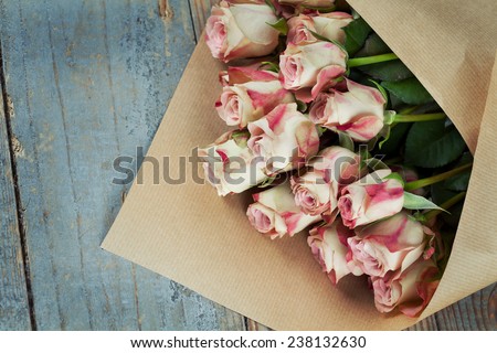 Bunch of beautiful roses packed in paper
