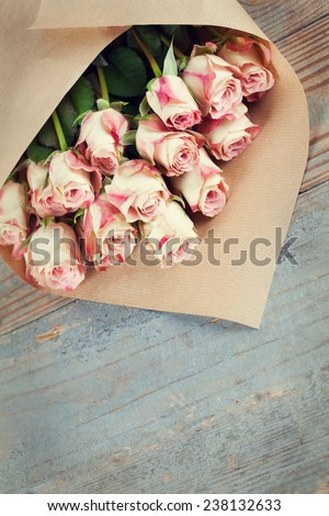 Bunch of beautiful roses packed in paper