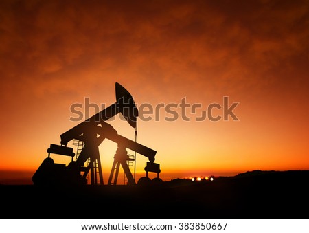 Oil Pumps at Dusk. Oil pumps producing oil at dusk.