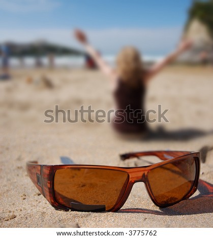 A women enjoying the sun with sunglasses in front