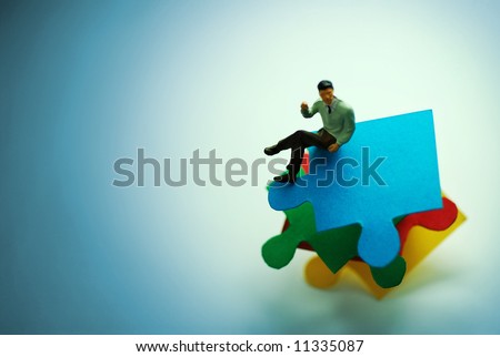 A man sat on puzzle pieces.