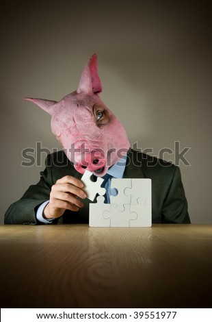 A businessman with a (pigs) mask finishing a puzzle.