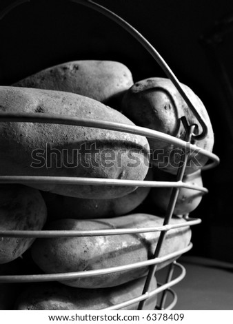 high contrast photo of potatoes in wire basket