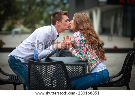 a hot man is kissing his beautiful young woman. couple in love. lovely day. happy day together.