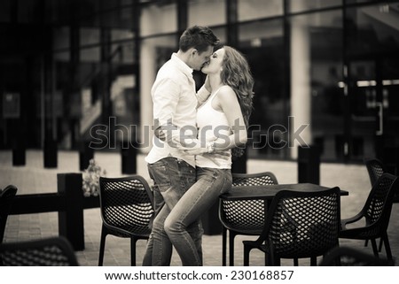 a hot man is kissing his beautiful young woman. couple in love. lovely day. happy day together.