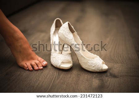 Women shoes. Wedding shoes. White shoes. Fashion shoes.Wooden background.