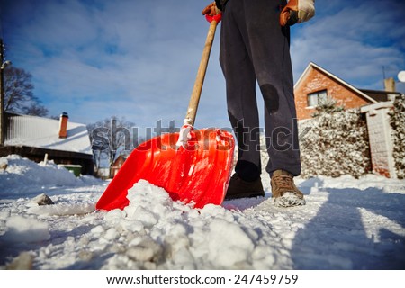 snow shovel cleans sidewalks in winter. Winter time.