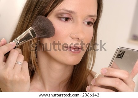 blond girl, young woman with pocket looking-glass putting make up