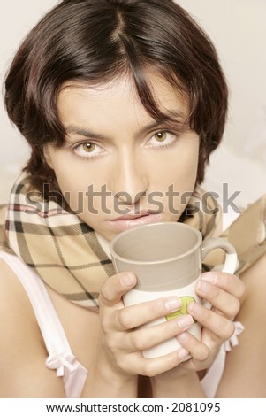 young woman, girl in a scarf drinking from a mug