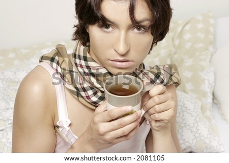 young woman, girl in a scarf drinking tea from a mug