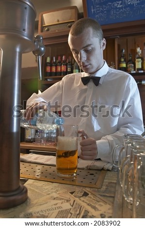 young waiter, barman pouring water into a beer, cheating