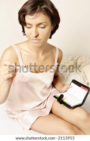 young woman checking body temperature- natural contraceptive method