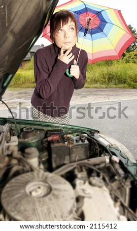 portrait of a young woman with an umbrella, standing by a broken car