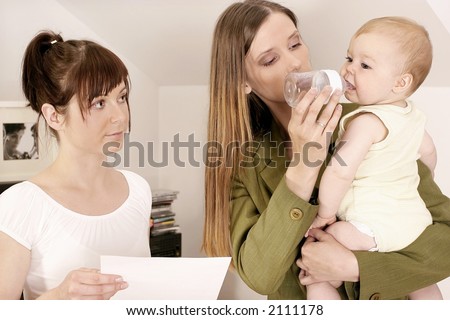 working mother ltalking to a babysitter about her duties
