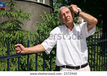 grey-haired, old man looking at the sky on a summer day