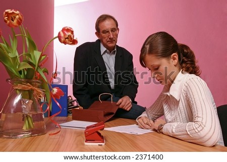 work environment- man bringing some gift for a woman working in office