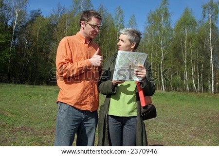 real estate agent showing location of piece of land to potential buyer