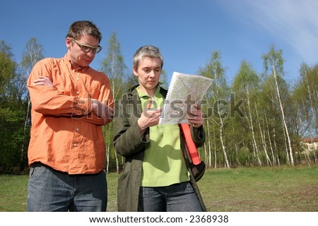 real estate agent showing location of piece of land to potential buyer