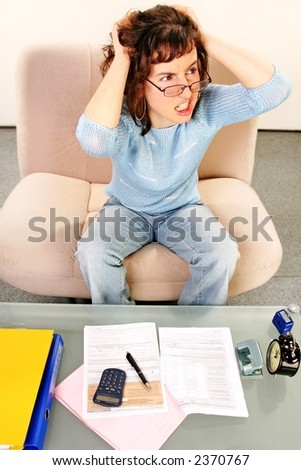 young woman doing some paperwork-filling tax form