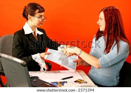 two young woman shake hands in work environment