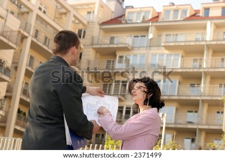 real estate agent showing flat location to potential buyer