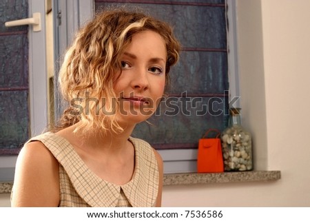 Young beautiful blonde woman with curly hair and romantic look.