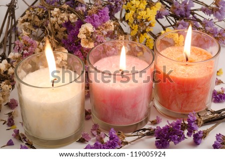 Three cup candles surrounded with dried wavy leaf sea lavender flowers