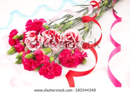 Two types carnations bouquet with four color ribbons on white background