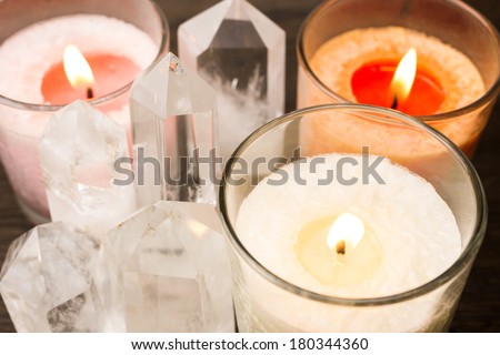 Close up of quartz crystals aligned and lighted color candles