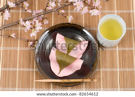 Japanese rice cake covered with sweetened bean jam wrapped in a preserved cherry leaf cherry blossoms