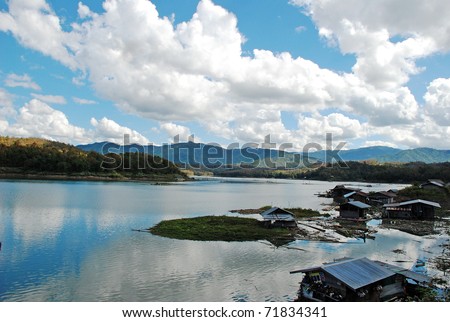 Landscape Waterfront home with river and blue sky, Thailand.