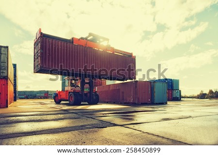Loading and unloading of containers in the port on a bright sunny day