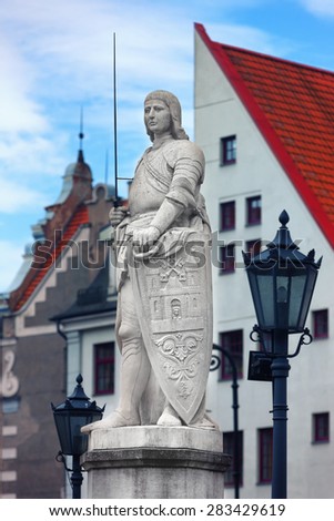 Sculpture of Roland in the Town Hall Square in Riga on background House of Blackheads