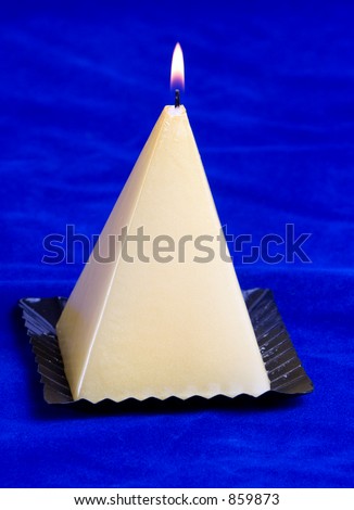 single pyramid shaped candle with flame