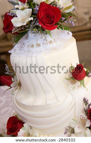 stock photo detail shot of brightly light simple three tiered wedding cake