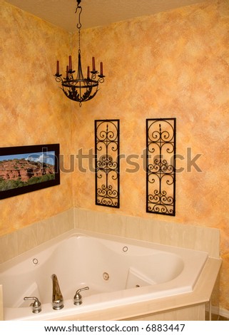 a custom faux finished wall surronds a luxury jetted tub (picture on the wall shot by me)