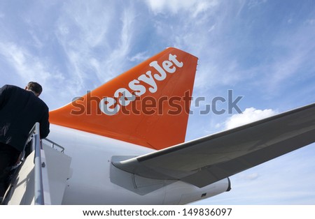 BERLIN - AUGUST 13: Business man boarding Easy Jet Flight from Berlin to London Gatwick, August 13, 2013 in Berlin, Germany